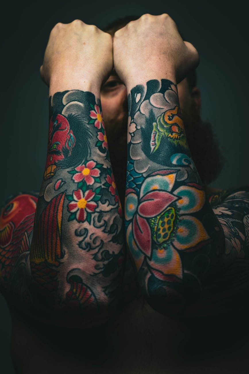 man with floral arm tattoos